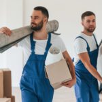 Two moving service employees in a room